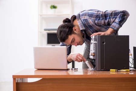 Young engineer repairing musical hi-fi system