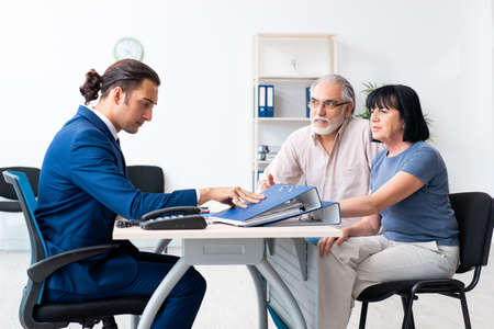 Financial advisor giving retirement advice to old coupleの写真素材