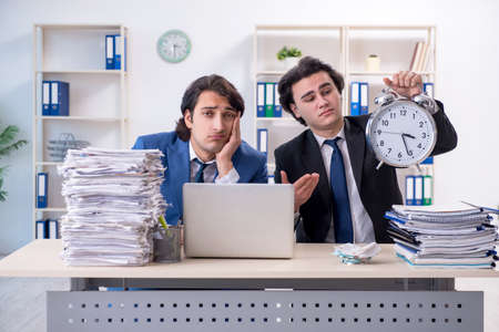 Two male colleagues unhappy with excessive work