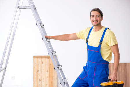 Young male contractor working indoorsの写真素材