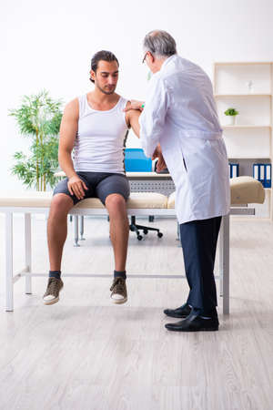 Young male patient visiting experienced doctorの写真素材