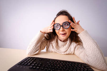 Funny nerd girl working on computer