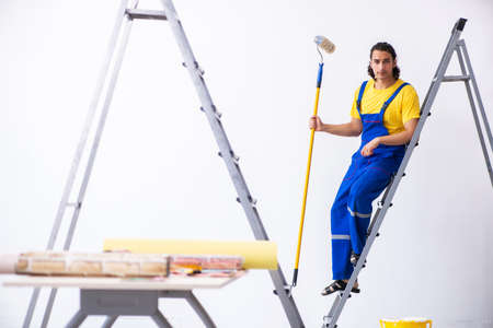 Young man contractor doing renovation at homeの写真素材