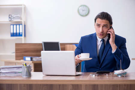 Young male businessman working in the officeの写真素材