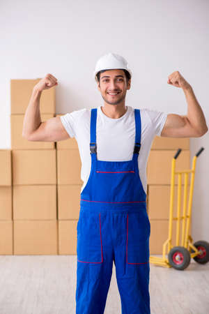 Young male professional mover doing home relocationの写真素材