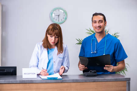 Two doctors working at the reception in the hospitalの写真素材