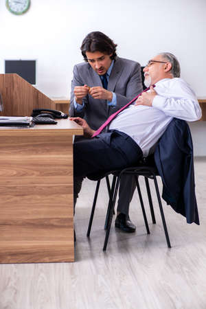 Male employee suffering from heart attack in the officeの写真素材