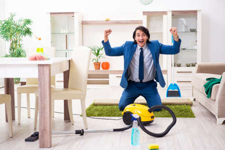 Young businessman cleaning the houseの写真素材
