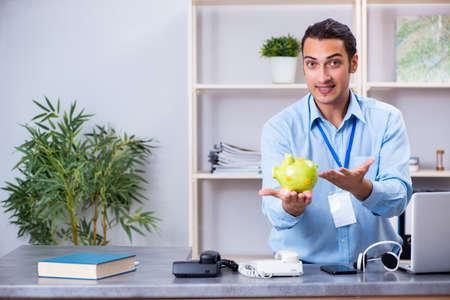 Young male travel agent working in the officeの写真素材