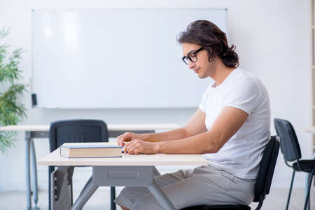 Young male student in front of whiteboardの写真素材