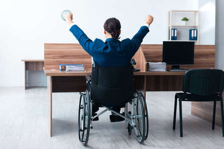 Young male employee in wheel-chairの写真素材