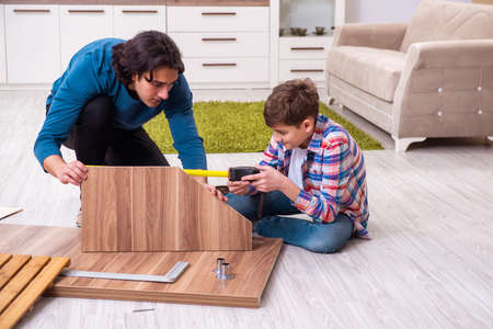 Young carpenter teaching his sonの写真素材