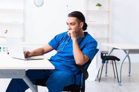 Young male doctor working in the clinicの写真素材