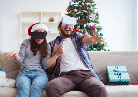 Happy family using virtual reality VR glasses during christmas