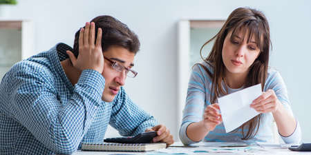 The young couple looking at family finance papers