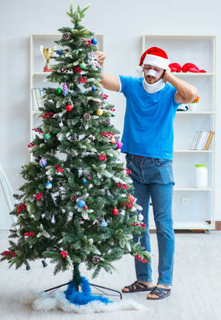 Injured man celebrating christmas at homeの写真素材