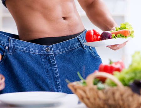 The young man in healthy eating and dieting conceptの写真素材