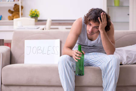 Unemployed man desperate at homeの写真素材