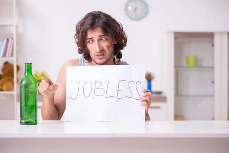 Unemployed man desperate at homeの写真素材