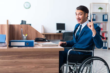 Young male employee in wheel-chairの写真素材