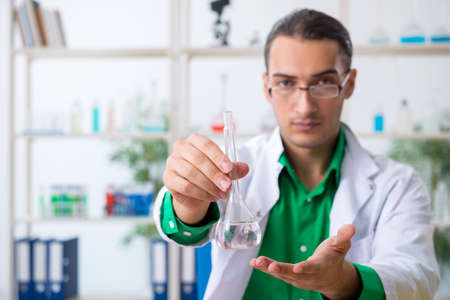 Young male chemist teacher in the labの写真素材