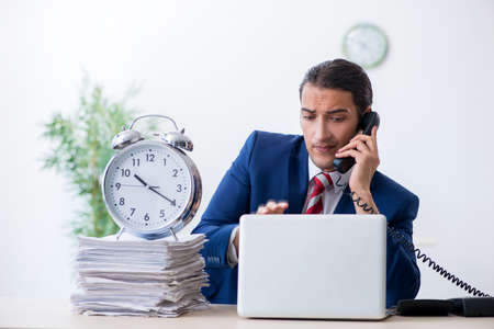 Young male businessman sitting in the officeの写真素材