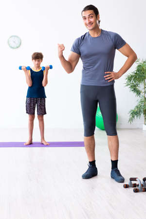 Young father and his son doing exercisesの写真素材