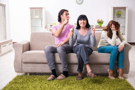 Young family and mother-in-law in family issues conceptの写真素材