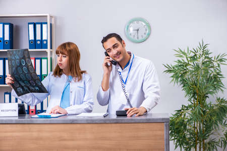 Two doctors working at the reception in the hospitalの写真素材