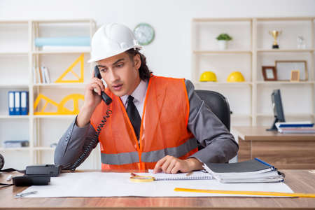 Young male architect working in the officeの写真素材