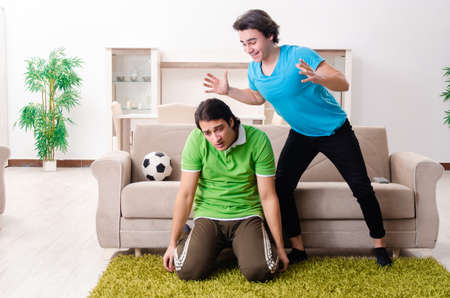 Friends watching football at homeの写真素材