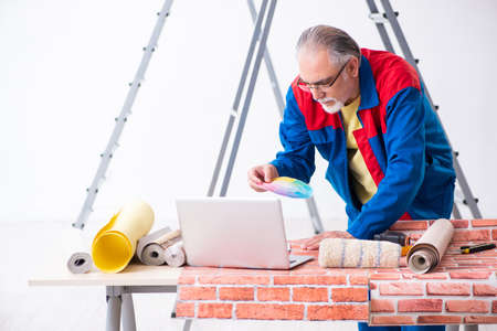 Old contractor doing renovation at homeの写真素材