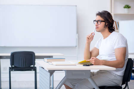 Young male student in front of whiteboardの写真素材