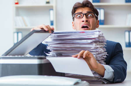 Businessman making copies in copying machine