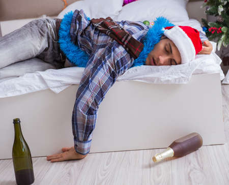 Man suffering hangover after christmas partyの写真素材