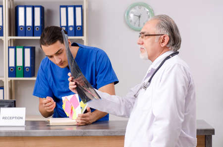 Two doctors talking at the reception in hospital