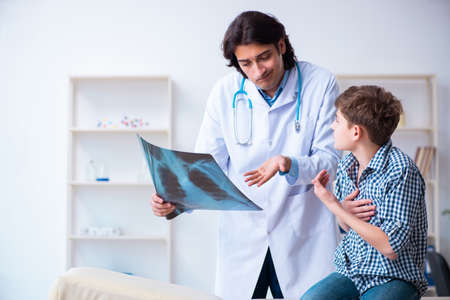 Male radiologist looking at boys imagesの写真素材