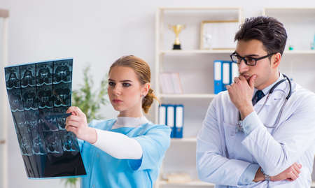 Two doctors examining x-ray images of patient for diagnosis