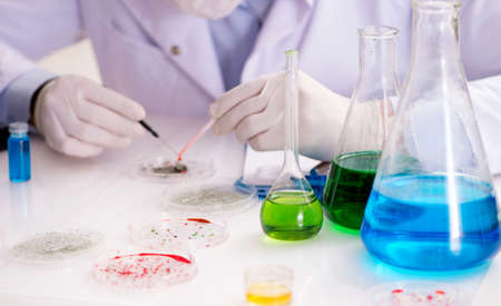 The male doctor working in the lab on virus vaccineの写真素材