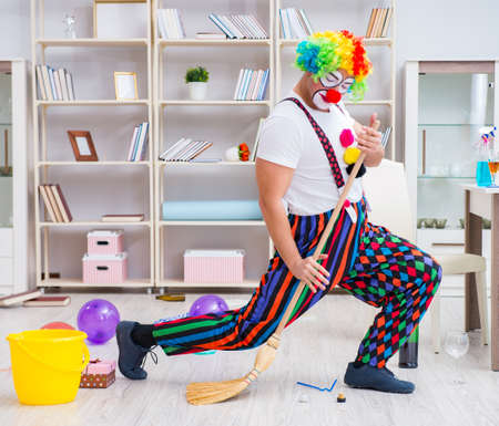 Funny clown doing cleaning at home