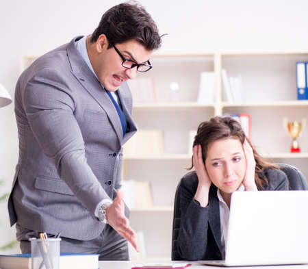 The angry boss unhappy with female employee performanceの写真素材