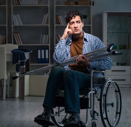 Man suffering from depression at wheelchairの写真素材