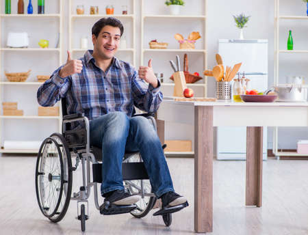 Disabled young man husband working in kitchen