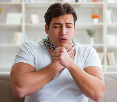 Young man suffering from sore throatの写真素材