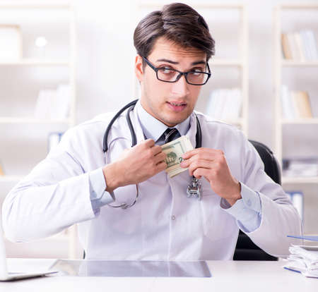 Doctor in corruption concept with being offered bribeの写真素材