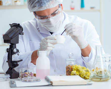 Chemist mixing perfumes in the labの写真素材