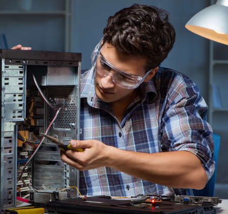The man repairing computer desktop with pliersの写真素材
