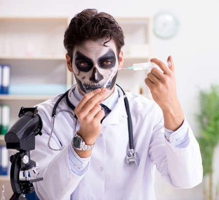 Scary monster doctor working in labの写真素材