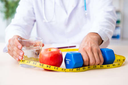 Young male doctor in sport and dieting conceptの写真素材
