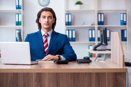 Young male businessman working in the officeの写真素材